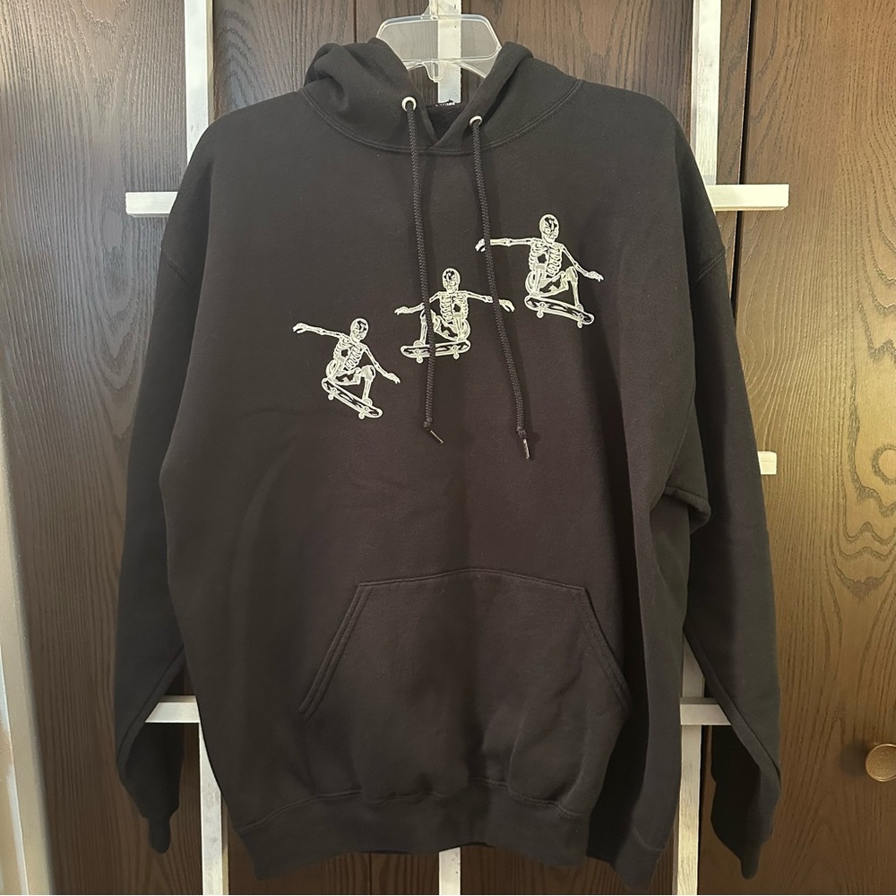 Black hoodie with skateboarding skeletons size large